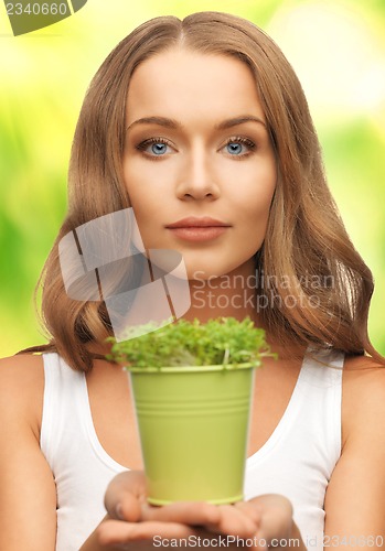Image of woman with green grass in pot