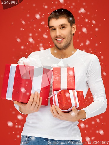Image of man holding many gift boxes
