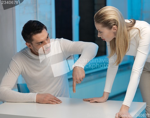 Image of man and woman working with something