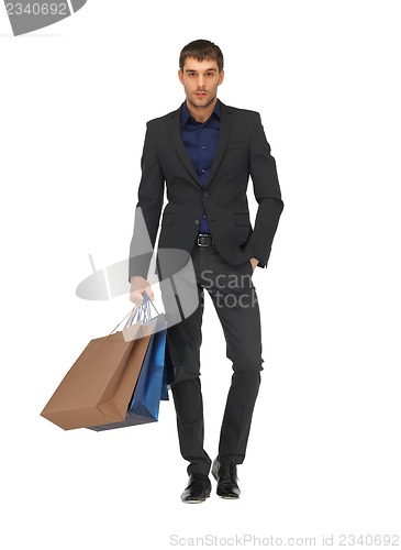 Image of handsome man in suit with shopping bags