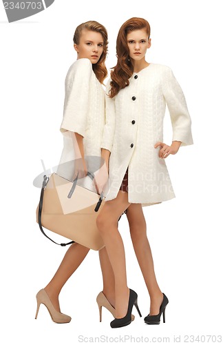 Image of two teenage girls in white coats with bag