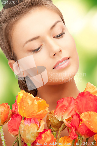 Image of lovely woman with red flowers