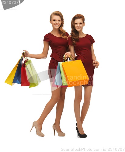 Image of teenage girls in red dresses with shopping bags