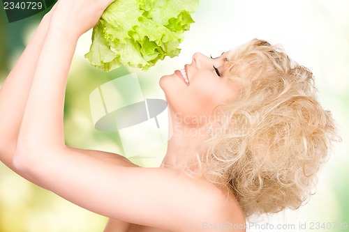 Image of beautiful housewife with lettuce