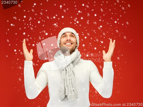 Image of handsome man in warm sweater, hat and scarf