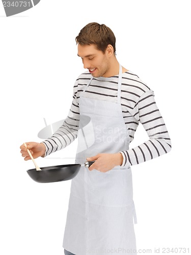 Image of handsome man with pan and spoon