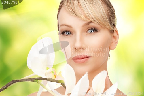 Image of beautiful woman with orchid flower