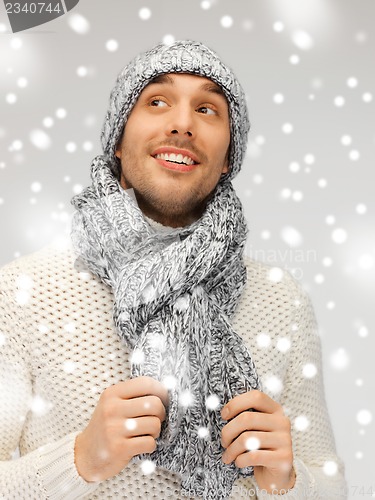 Image of handsome man in warm sweater, hat and scarf