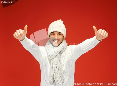 Image of handsome man in warm sweater, hat and scarf