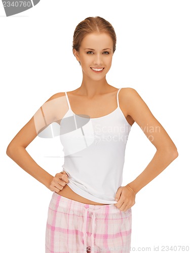 Image of happy and smiling woman in cotton pajamas