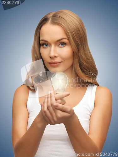 Image of woman with energy saving bulb