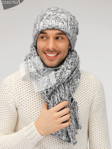 Image of handsome man in warm sweater, hat and scarf