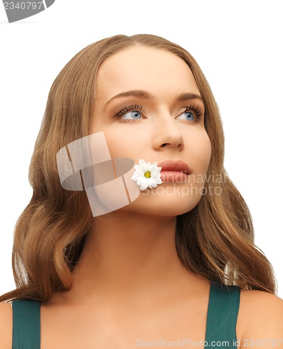 Image of woman with camomile in mouth