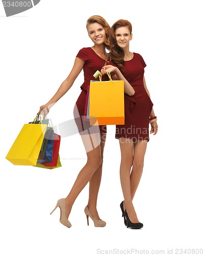 Image of teenage girls in red dresses with shopping bags