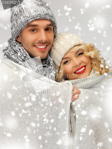 Image of family couple under warm blanket