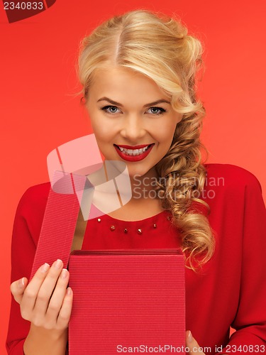 Image of lovely woman in red dress with opened gift box