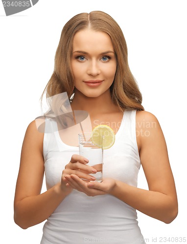 Image of woman with lemon slice on glass of water