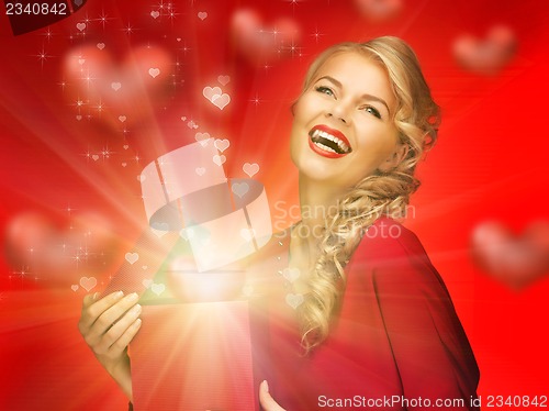 Image of lovely woman in red dress with valentine gift box