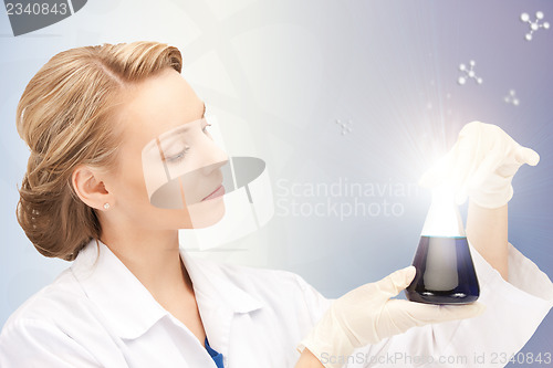 Image of lab worker holding up test tube