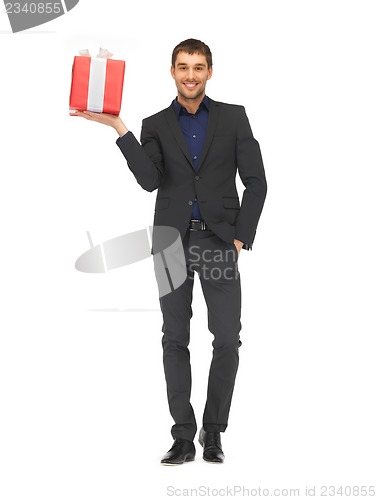 Image of handsome man in suit with a gift box