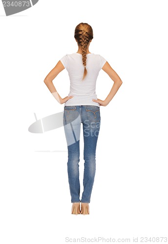 Image of rear view of woman in blank white t-shirt