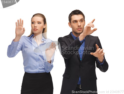 Image of man and woman working with something imaginary