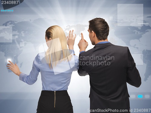 Image of man and woman working with virtual touch screens