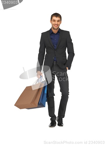 Image of handsome man in suit with shopping bags