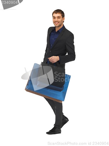 Image of handsome man in suit with shopping bags