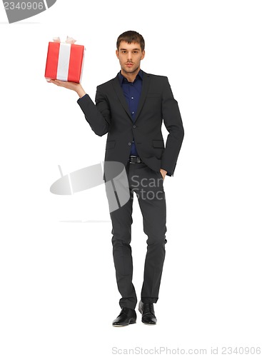 Image of handsome man in suit with a gift box