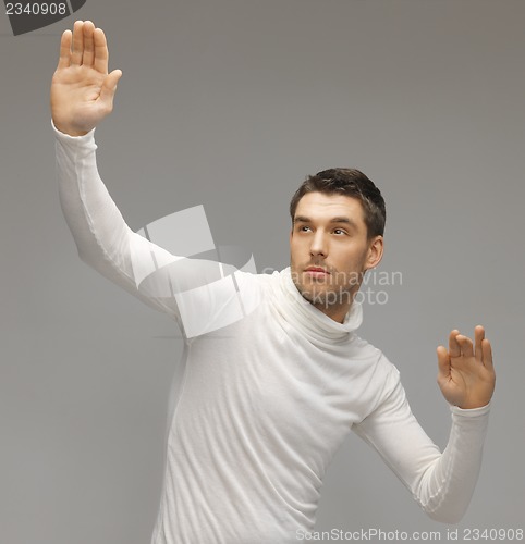 Image of man working with something imaginary