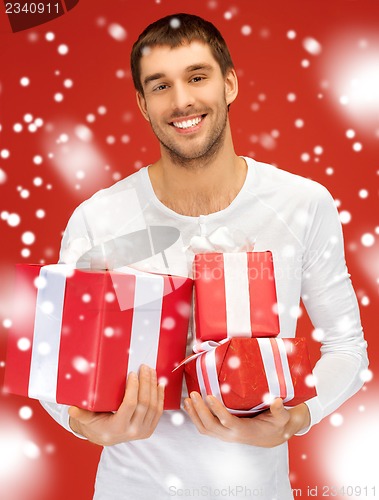Image of man holding many gift boxes