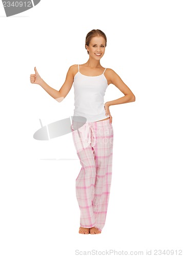 Image of woman in cotton pajamas showing thumbs up