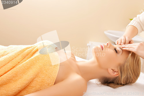 Image of beautiful woman in massage salon