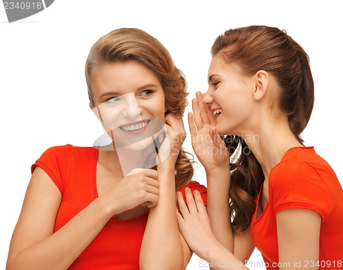 Image of two talking teenage girls in red t-shirts