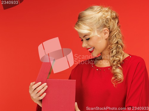 Image of lovely woman in red dress with opened gift box