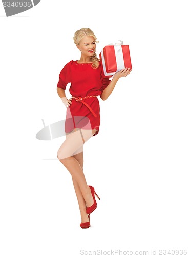 Image of lovely woman in red dress with present