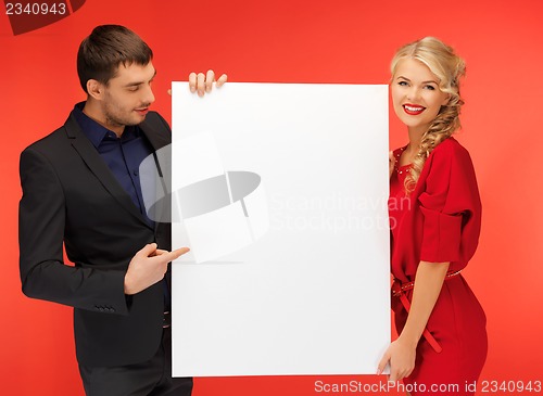 Image of couple holding big blank board