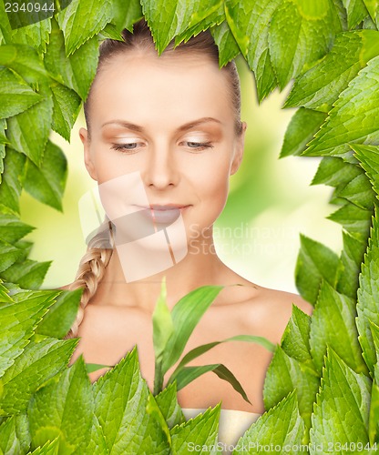 Image of beautiful woman with green leaves
