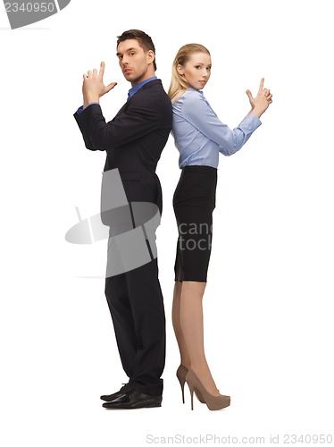 Image of man and woman making a gun gesture