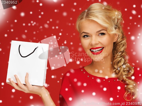 Image of lovely woman in red dress with shopping bag