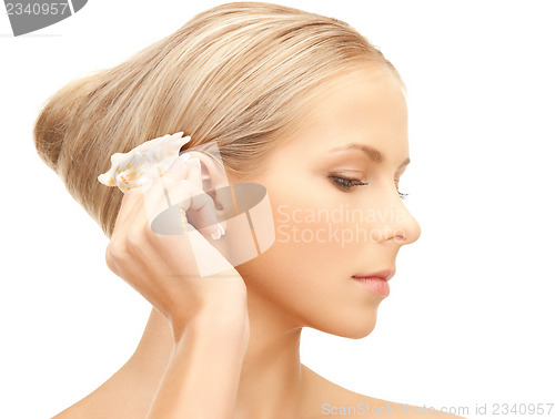 Image of beautiful woman with seashell