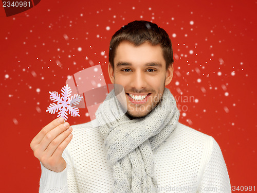 Image of man in warm sweater and scarf with snowflake