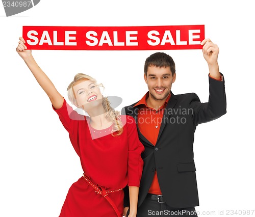Image of man and woman with sale sign