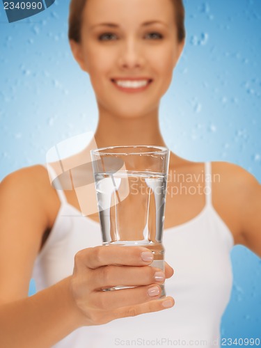 Image of woman hands holding glass of water