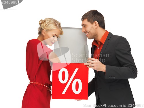 Image of man and woman with percent sign