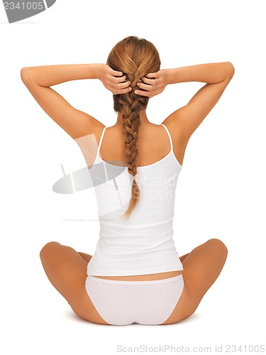 Image of woman in undrewear practicing yoga lotus pose