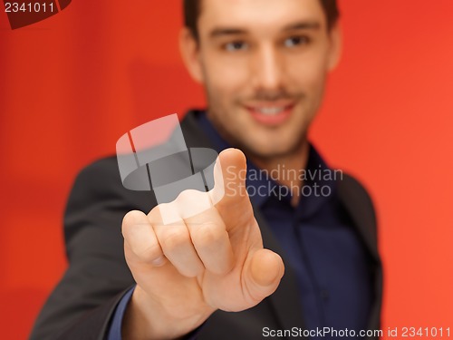 Image of handsome man in suit pressing virtual button