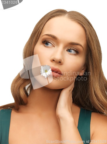 Image of woman with camomile in mouth