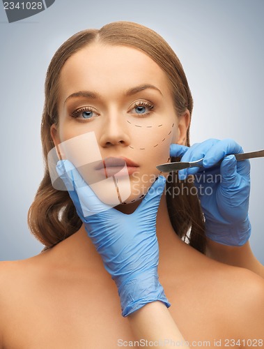 Image of woman face and beautician hands